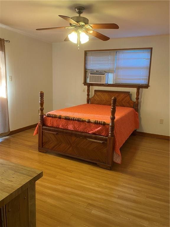 bedroom with ceiling fan, cooling unit, and light wood-type flooring