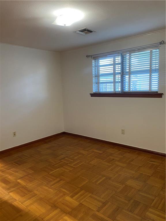 empty room with parquet flooring