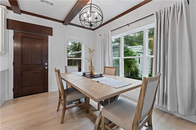 dining space featuring a chandelier, beamed ceiling, and light hardwood / wood-style floors