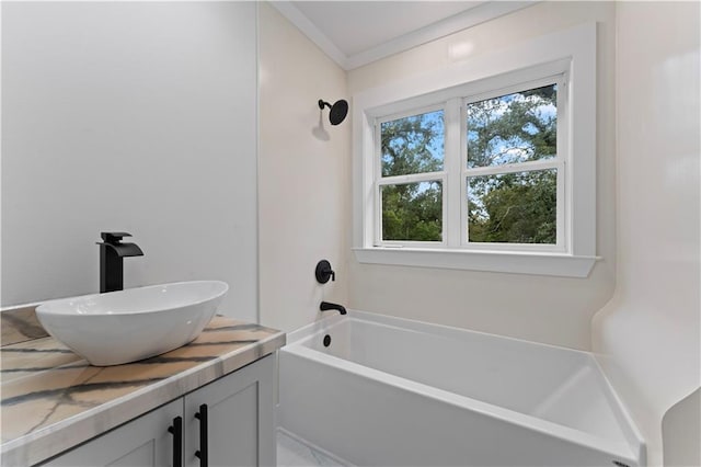 bathroom with shower / bathing tub combination, crown molding, and sink