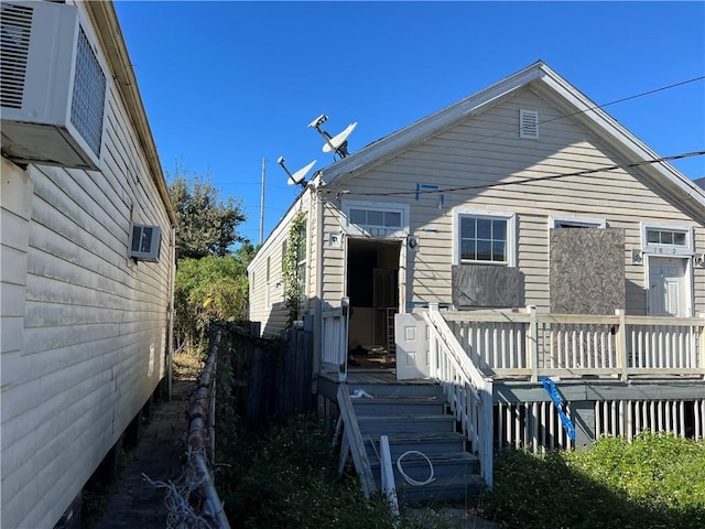 back of property featuring a wooden deck