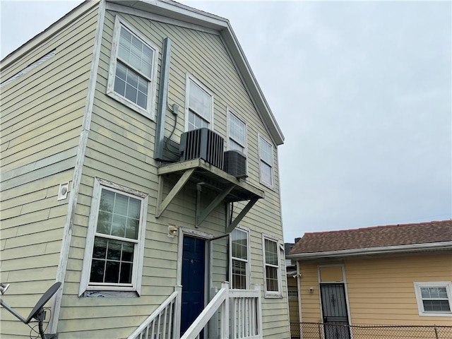 rear view of property featuring cooling unit