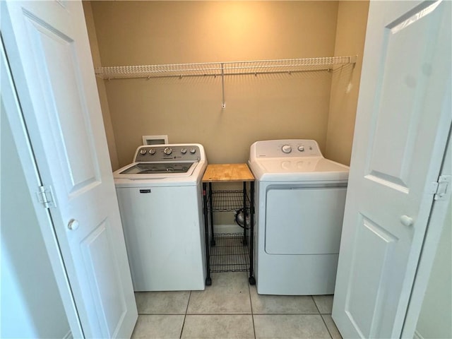 laundry room with light tile patterned flooring and independent washer and dryer