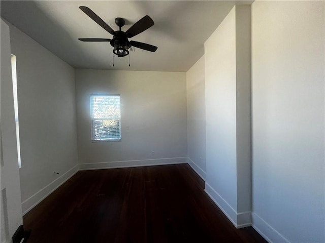 spare room featuring ceiling fan and dark wood-type flooring