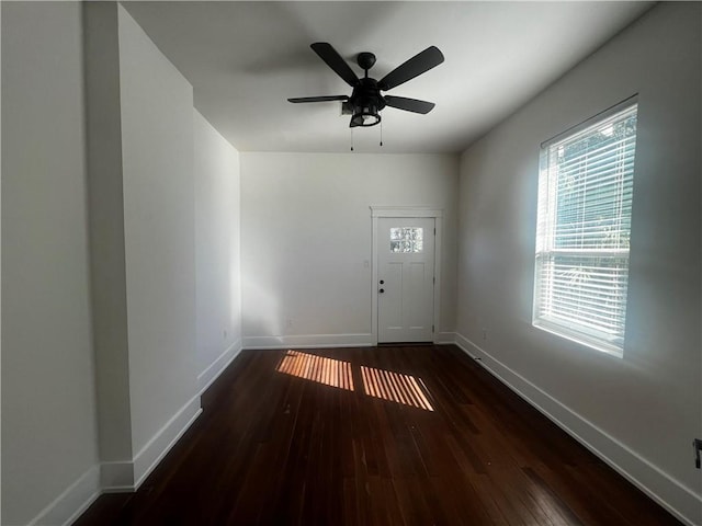 interior space with ceiling fan and dark hardwood / wood-style flooring