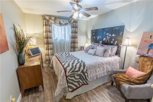 bedroom featuring hardwood / wood-style flooring and ceiling fan