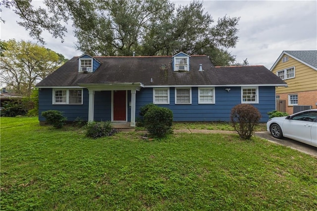 cape cod home with a front yard