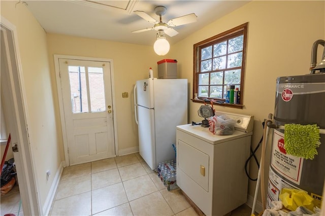 washroom featuring a healthy amount of sunlight, washer / dryer, light tile patterned floors, and gas water heater