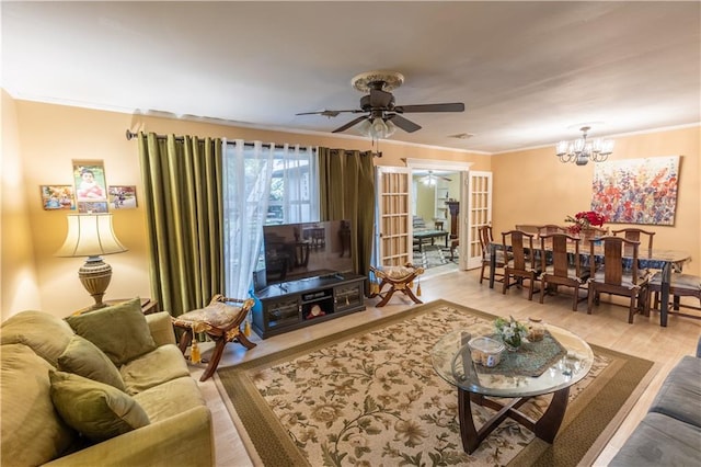 living room with ceiling fan with notable chandelier, light hardwood / wood-style floors, and crown molding