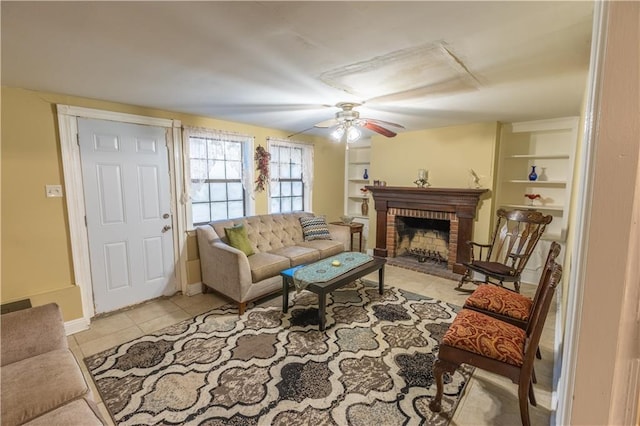 living room featuring ceiling fan, light tile patterned floors, and a fireplace