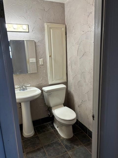 bathroom featuring tile patterned floors, toilet, and sink