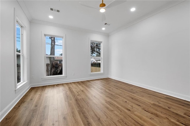 spare room featuring crown molding, light hardwood / wood-style flooring, and ceiling fan