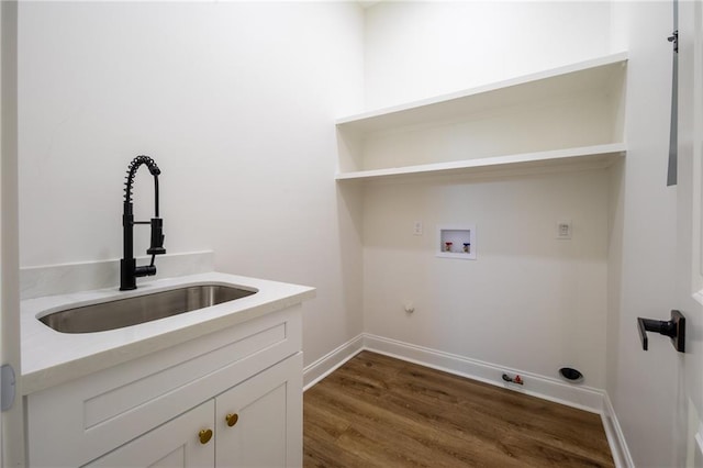 washroom featuring cabinets, hookup for a washing machine, dark hardwood / wood-style flooring, gas dryer hookup, and sink