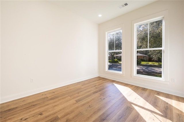 unfurnished room with light wood-type flooring