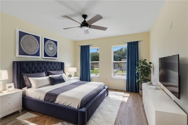 bedroom with ceiling fan and light hardwood / wood-style flooring