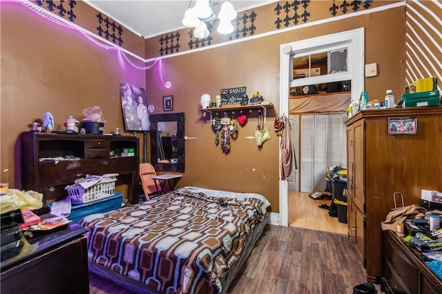 bedroom with hardwood / wood-style floors and ornamental molding