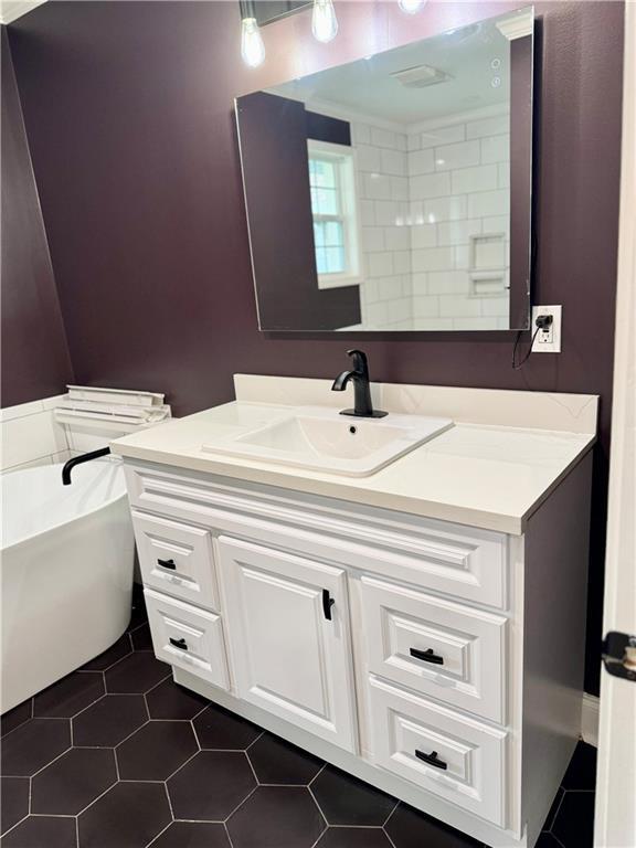 bathroom with tile patterned flooring and vanity