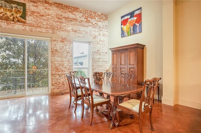 dining space featuring a healthy amount of sunlight and concrete floors