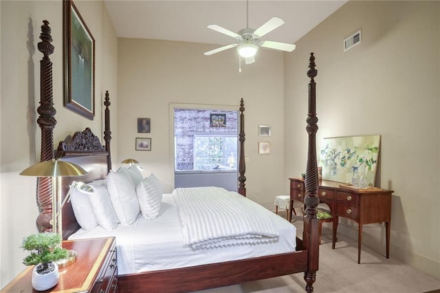 bedroom featuring ceiling fan, light colored carpet, and vaulted ceiling