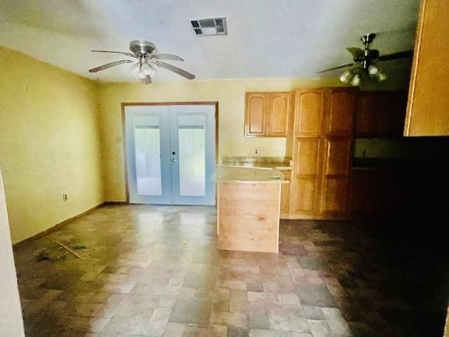 kitchen featuring ceiling fan, light brown cabinets, and french doors