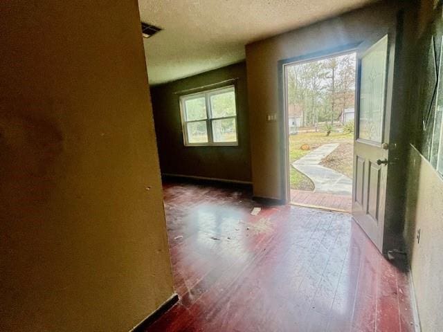 interior space with dark hardwood / wood-style floors and a textured ceiling