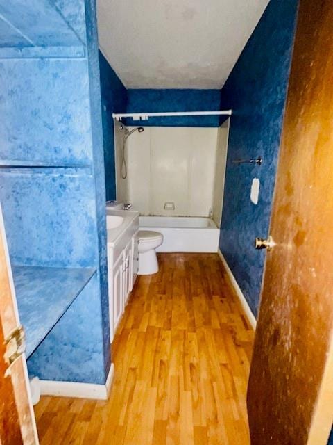 full bathroom featuring vanity, toilet, hardwood / wood-style floors, and bathing tub / shower combination