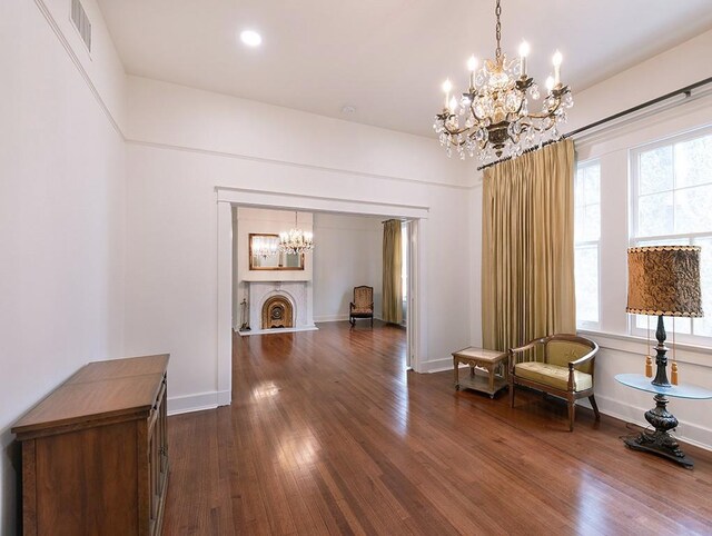 living area featuring dark wood-type flooring and a chandelier