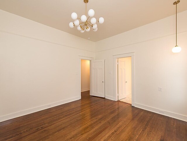 interior space featuring dark wood-type flooring and a chandelier