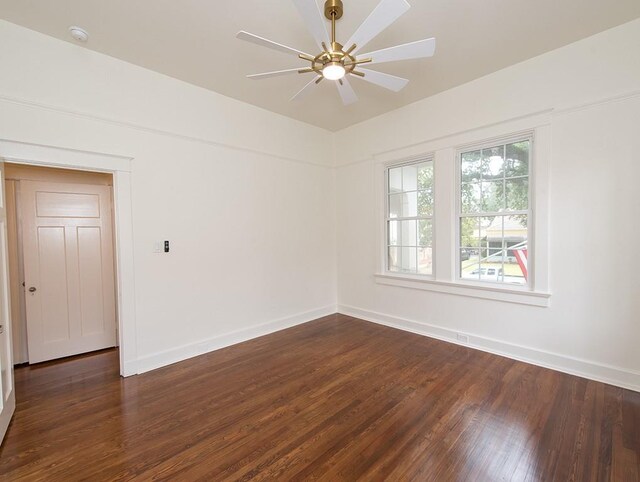 spare room featuring dark wood-type flooring and ceiling fan