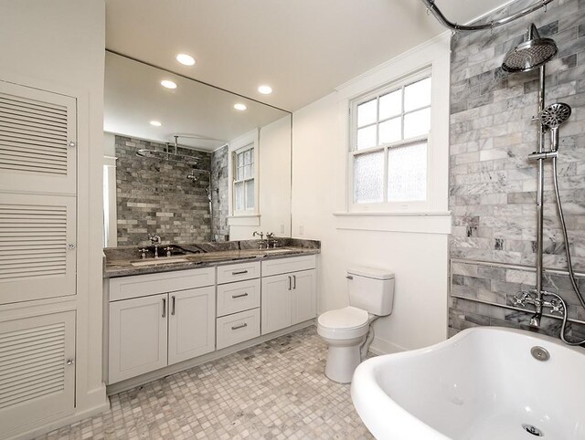 full bathroom featuring toilet, independent shower and bath, and vanity