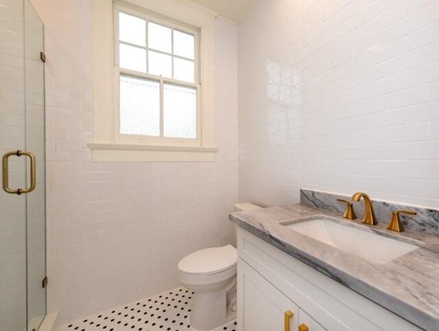 bathroom featuring toilet, walk in shower, crown molding, and vanity