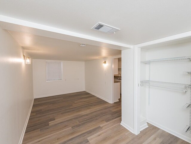 basement with hardwood / wood-style flooring