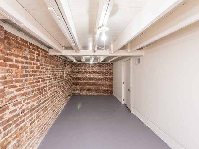 basement with brick wall