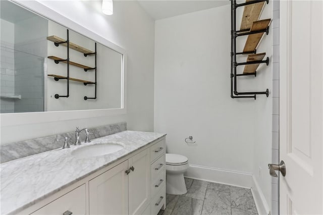 bathroom featuring a shower, vanity, and toilet