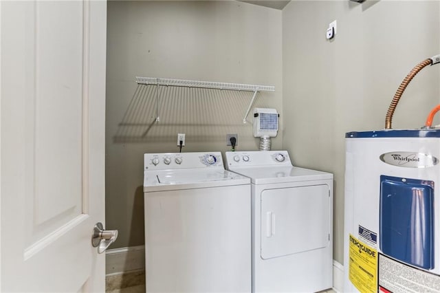 washroom featuring electric water heater and separate washer and dryer