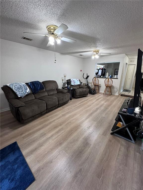 living room with hardwood / wood-style flooring and a textured ceiling