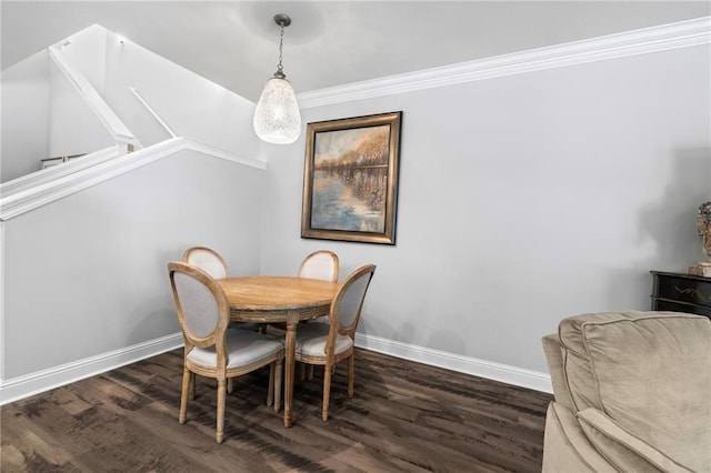 dining area featuring dark hardwood / wood-style flooring and ornamental molding