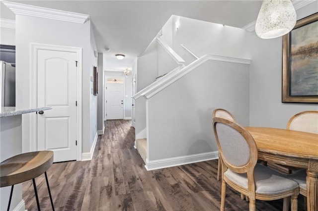 dining room featuring dark hardwood / wood-style floors and crown molding