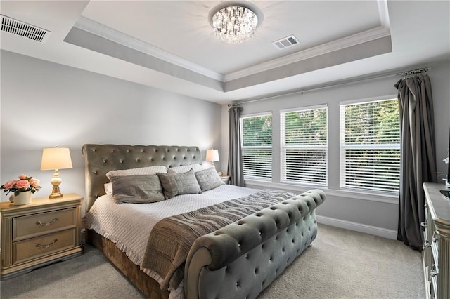 carpeted bedroom featuring a chandelier, crown molding, and a tray ceiling