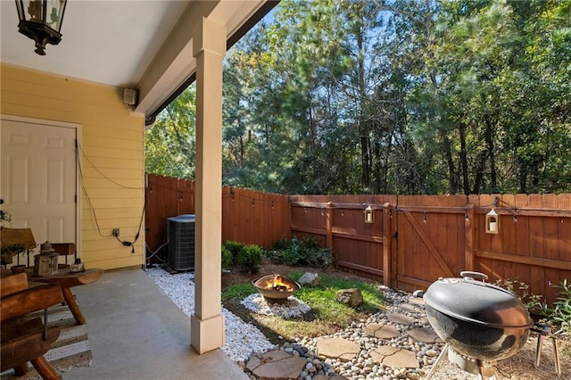 view of patio featuring cooling unit and an outdoor fire pit