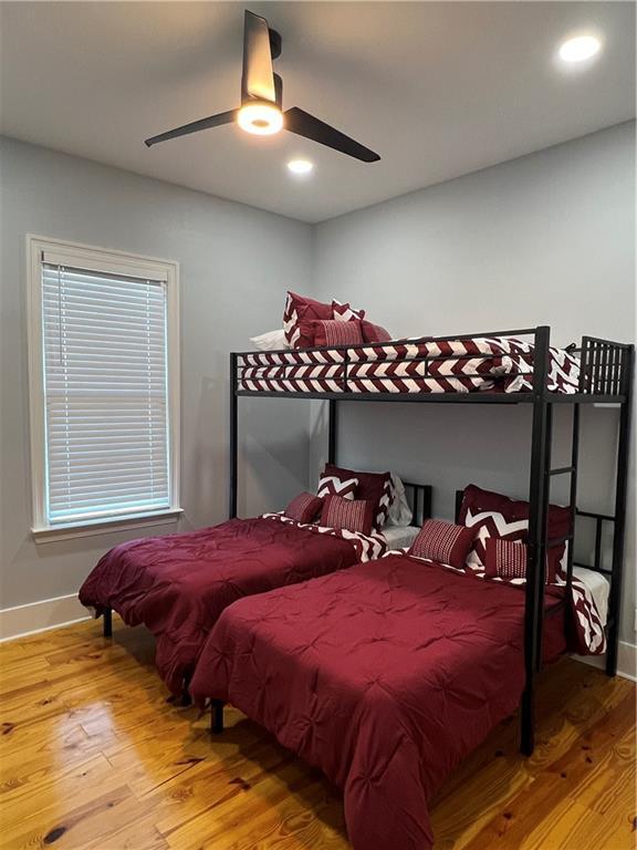 bedroom with hardwood / wood-style floors and ceiling fan