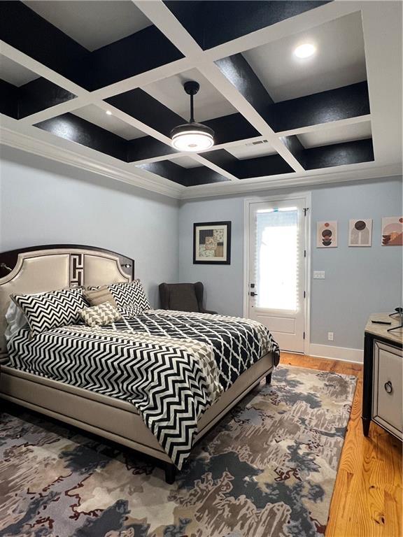 bedroom featuring beamed ceiling, hardwood / wood-style flooring, ceiling fan, and coffered ceiling