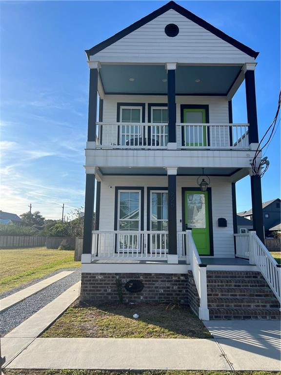 view of front of home with covered porch and a balcony