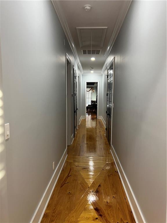 hall featuring parquet flooring and crown molding