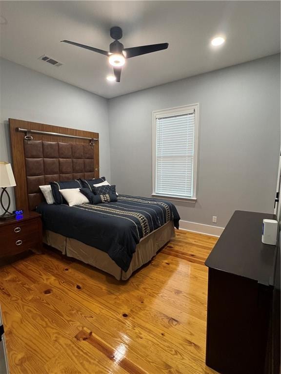 bedroom with light hardwood / wood-style flooring and ceiling fan