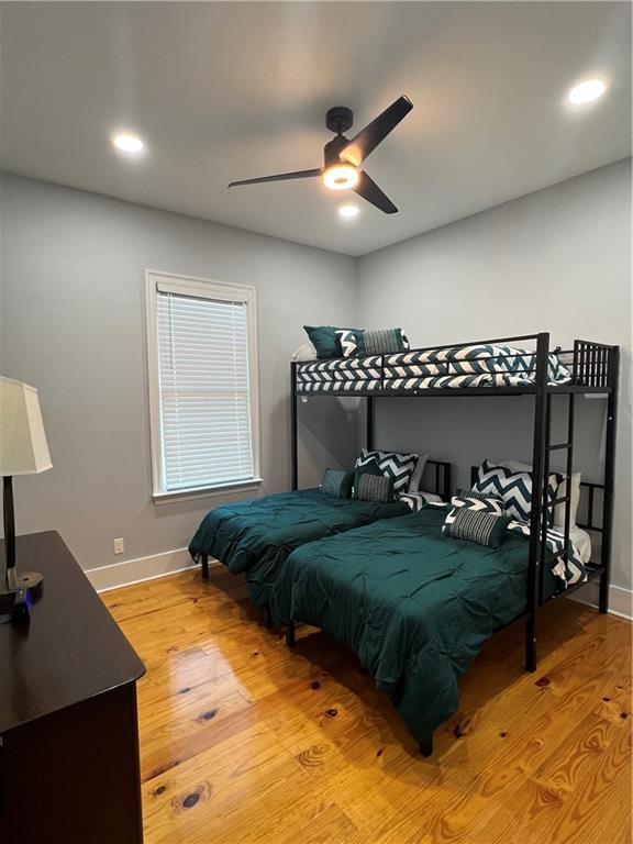 bedroom with light wood-type flooring and ceiling fan