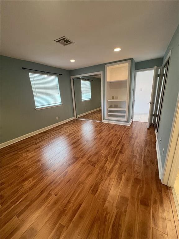 unfurnished bedroom with hardwood / wood-style floors