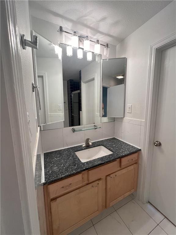 bathroom with vanity and a textured ceiling