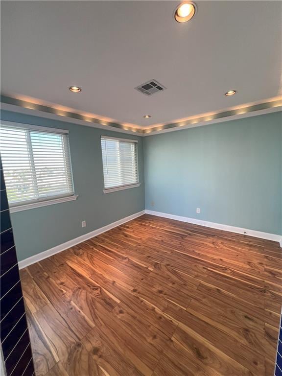 spare room with hardwood / wood-style floors