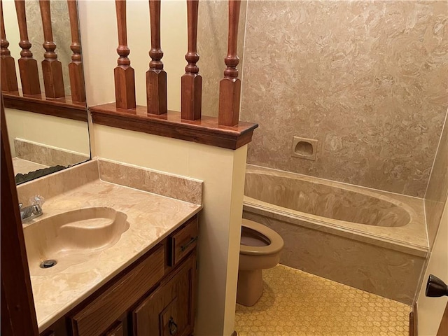 bathroom featuring a tub, vanity, and toilet